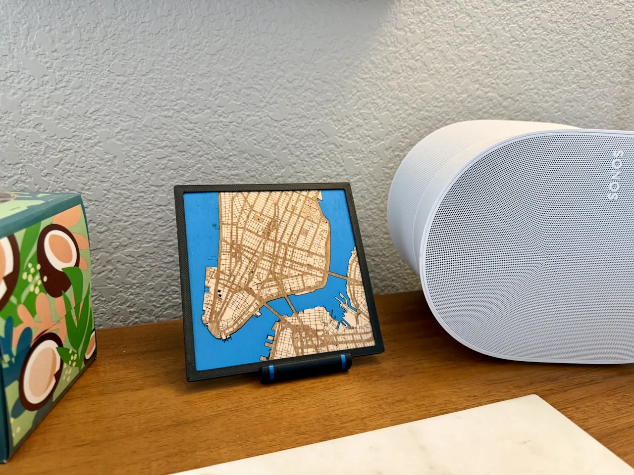 A laser-cut map of Lower Manhattan on a stand on a walnut credenza